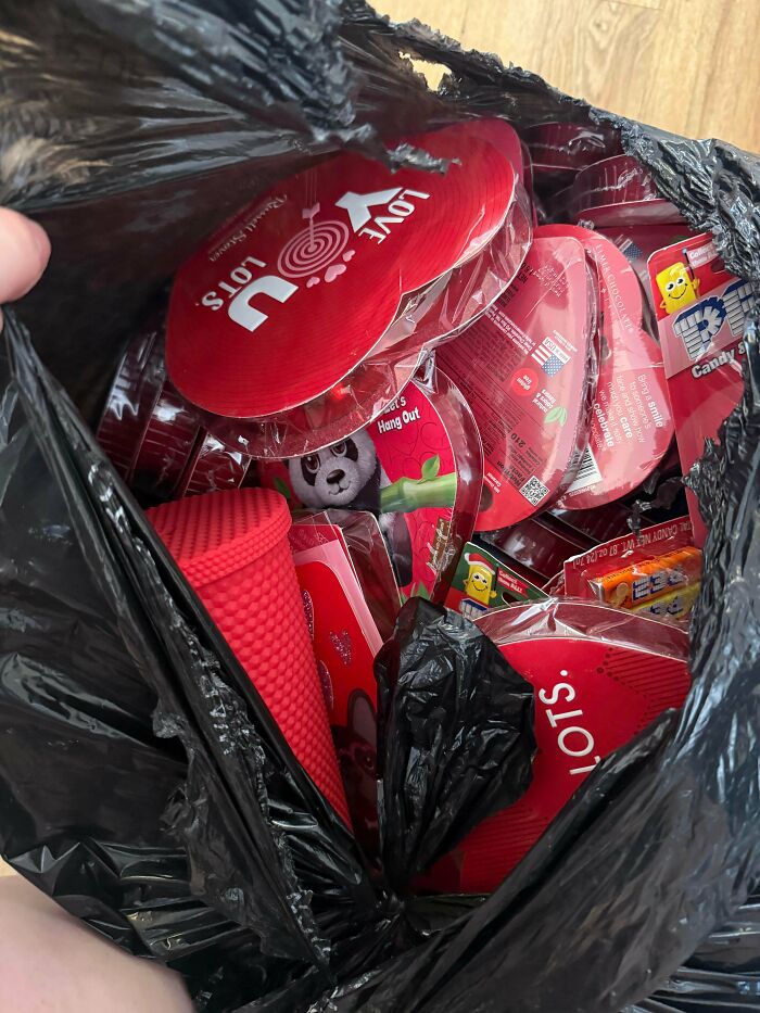 A black bag full of new red and black Valentine's Day themed items, a lucky find from dumpster diving.