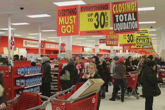 Busy store with 'Everything Must Go' and 'Closing Sale' signs, a quick fact about retail liquidation.