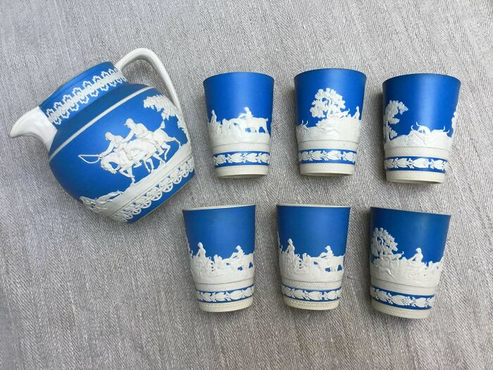 A set of remarkable antique blue and white Wedgwood cups and pitcher, depicting classical scenes.