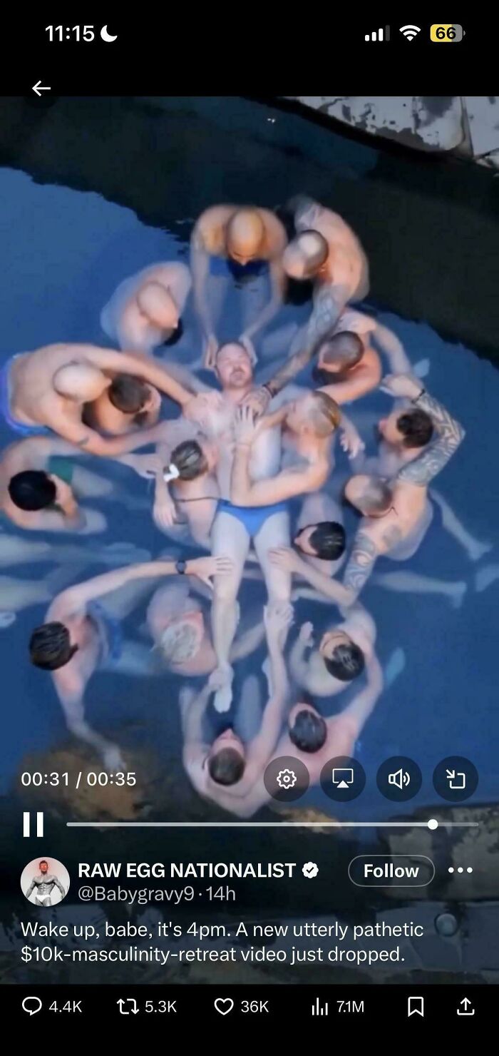 Man surrounded by others floating in water at masculinity retreat