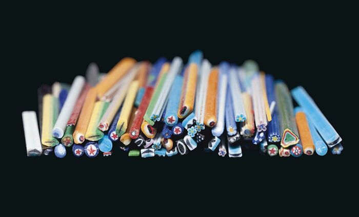 Colorful Roman mosaic glass rods lined up together as incredible historical finds.
