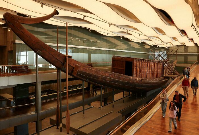 Large ancient wooden ship suspended inside a museum, one of the top historical finds.