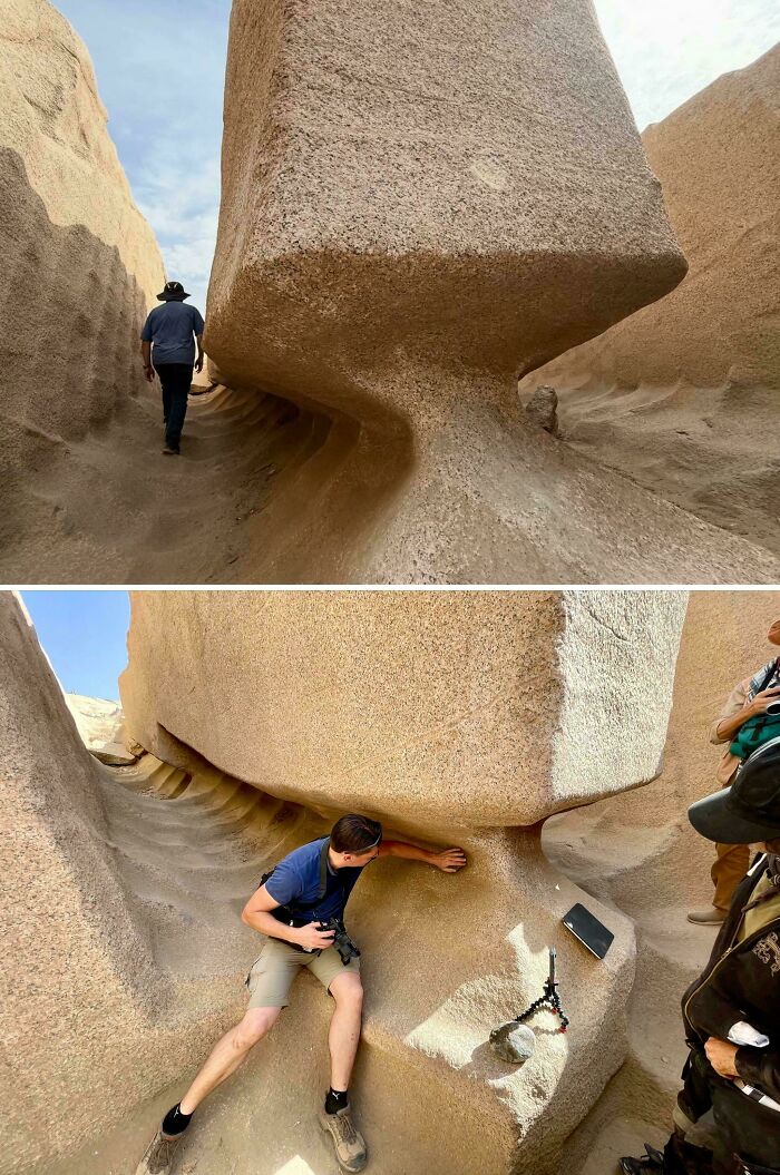 People inspecting massive carved stone blocks at an ancient quarry site, revealing impressive historical finds.