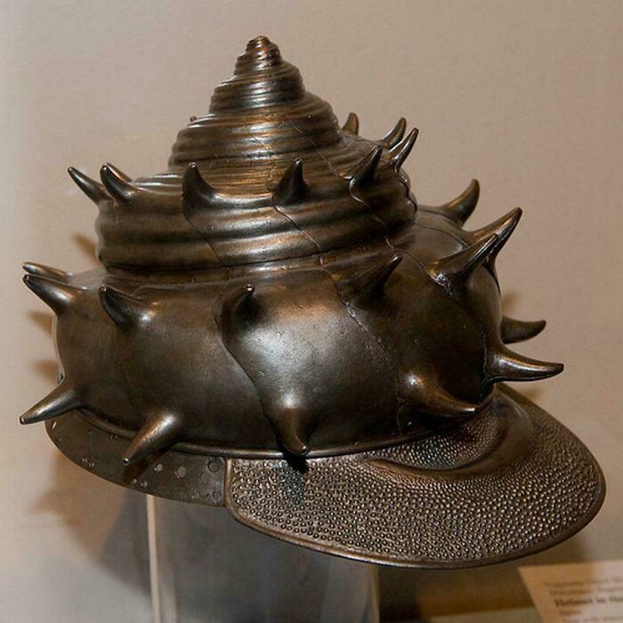 A detailed Japanese sea snail shell helmet made of metal, among extraordinary historical finds.
