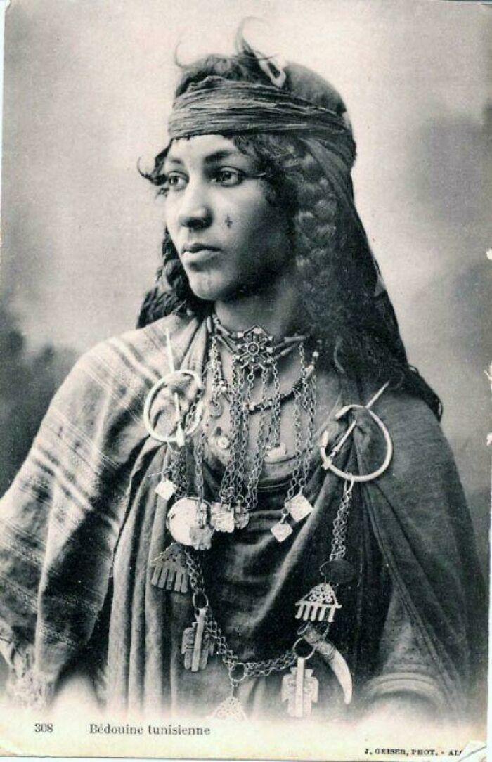 A woman in traditional attire and jewelry, an example from fascinating historical photos.