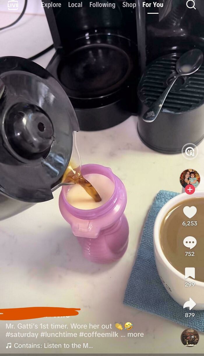 Pouring coffee into pink baby bottle near cup on kitchen counter