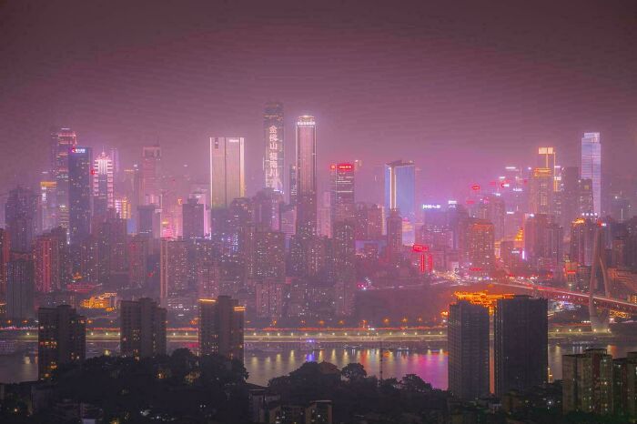 City skyline glowing with neon lights in urban hell atmosphere