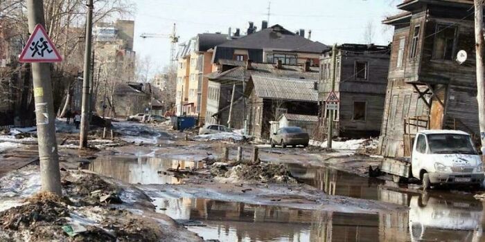 Muddy flooded street with damaged buildings in urban hell environment
