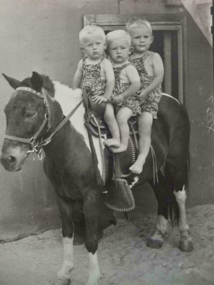 Candid old photos: Three young children riding a pony outdoors, an image revealing what the world looked like generations ago.