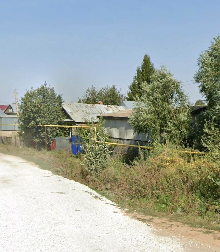 Rundown rural house and overgrown land in urban hell setting