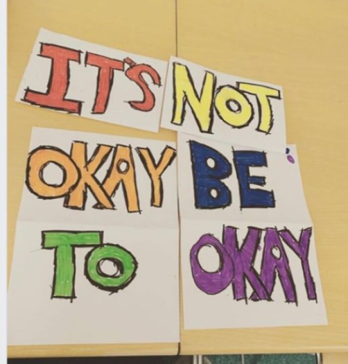 Colorful handwritten sign reading its not okay to be okay, an example of signs that went wrong and turned comedic gold.