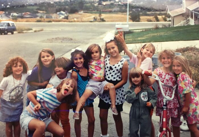 Group of kids in playful and awkward childhood photo, capturing hilariously awkward moments shared by people.