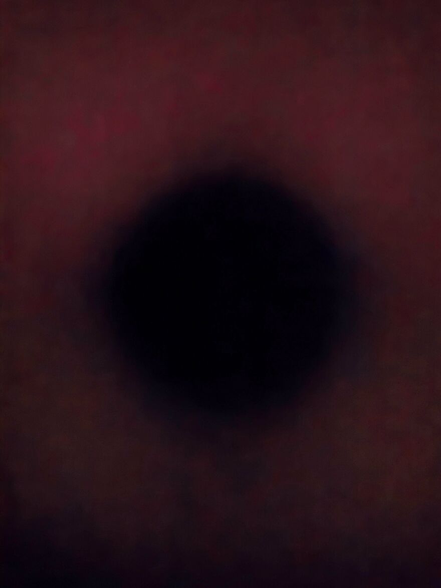 Close-up of a dark circular shape with blurred edges, showcasing a weird and unexplainable visual phenomenon.