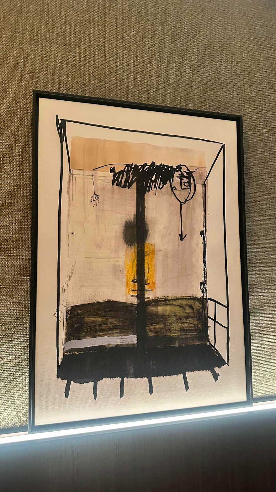 Abstract framed artwork on textured wall, showcasing weird and unexplainable shapes in a modern interior setting.