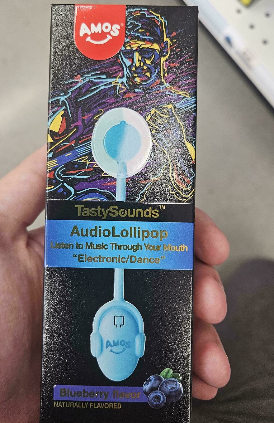 Hand holding weird and unexplainable TastySounds AudioLollipop packaging with blueberry flavor and electronic dance theme.