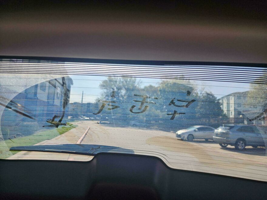View through a car window showing strange symbols drawn on the foggy glass, part of weird and unexplainable things experienced.