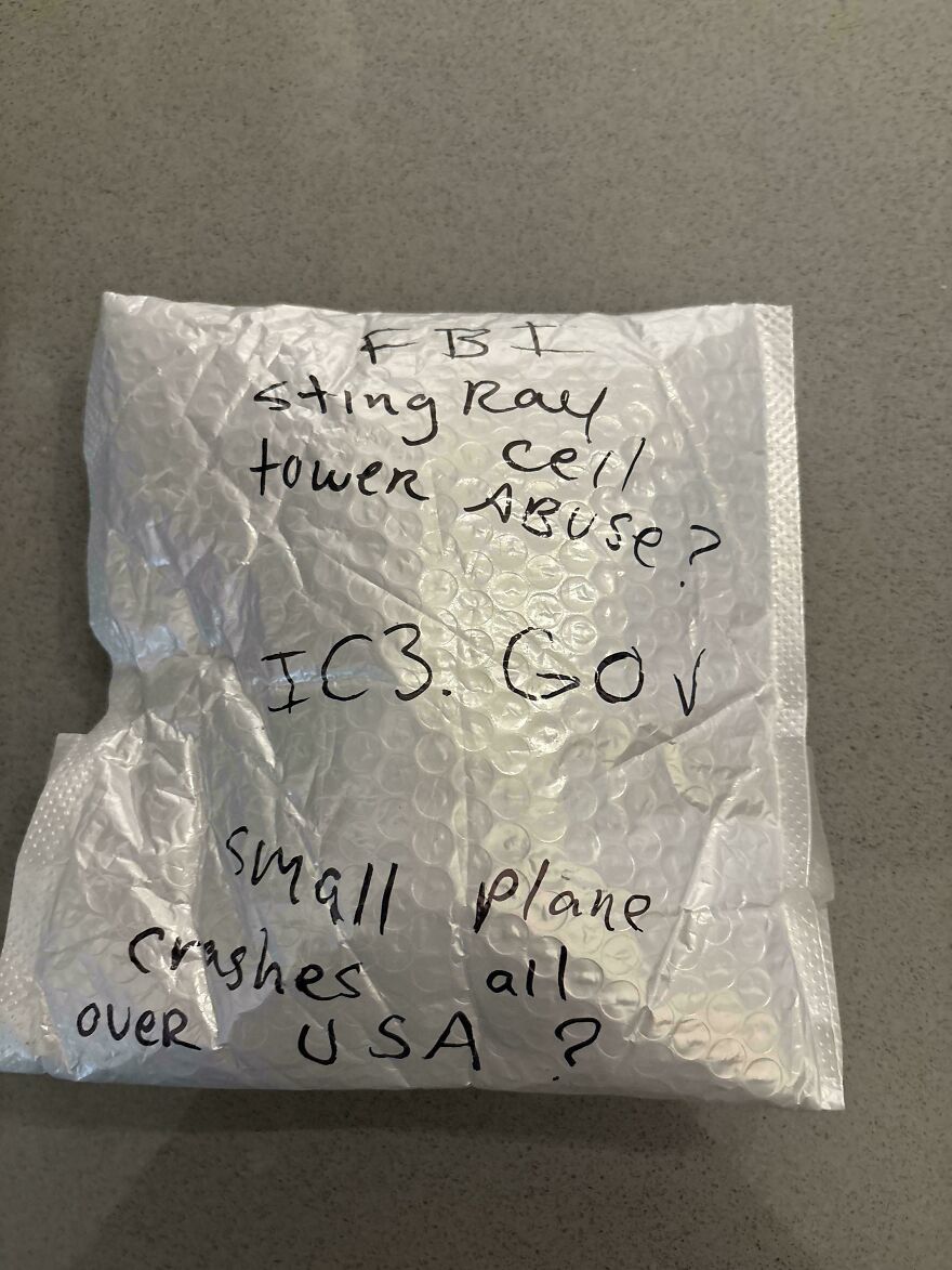 Handwritten mysterious message on bubble wrap mentioning FBI sting ray tower, cell a***e, and small plane crashes in the USA.