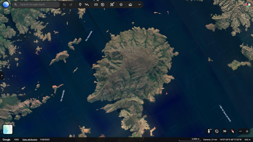 Satellite view of a weird and unexplainable land formation surrounded by water, captured on Google Earth.