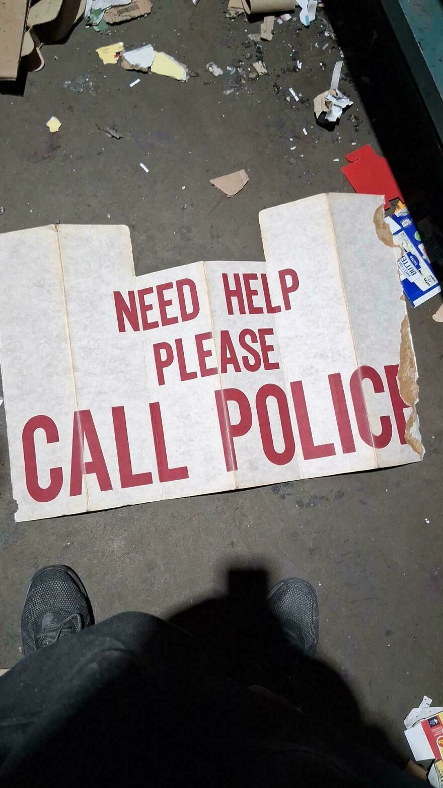 Worn sign on the ground reading need help please call police, one of the weird and unexplainable things experienced.