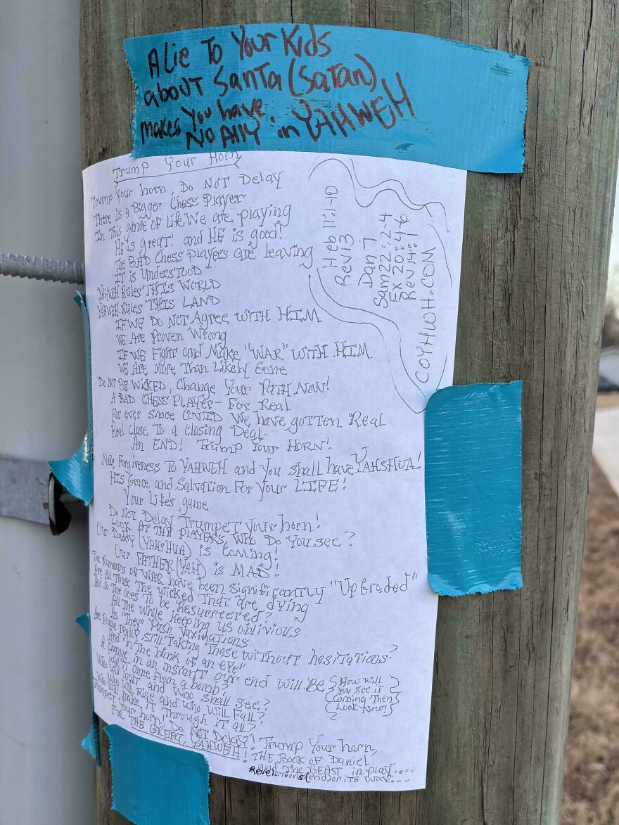 Handwritten mysterious note taped to a wooden pole, an example of weird and unexplainable things people experienced.