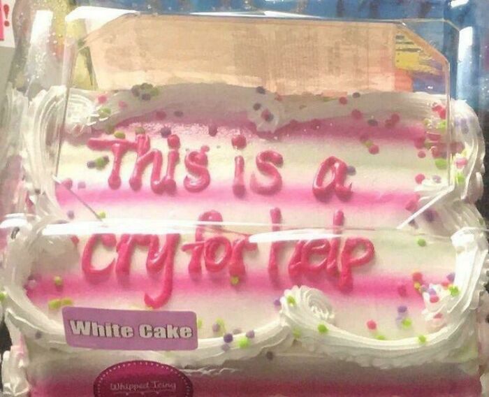 Cake with messy pink icing text saying this is a cry for help, a funny and relatable meme about problems.