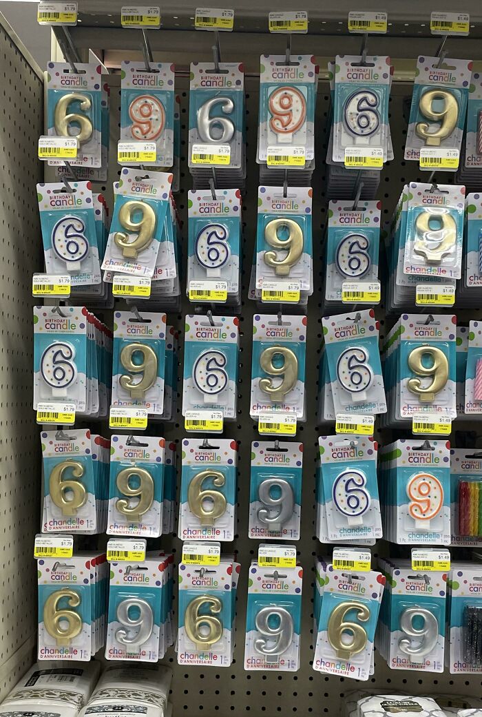Display of birthday candles with repeated numbers 6 and 9, illustrating mild vandalism and numbering confusion on store shelves.