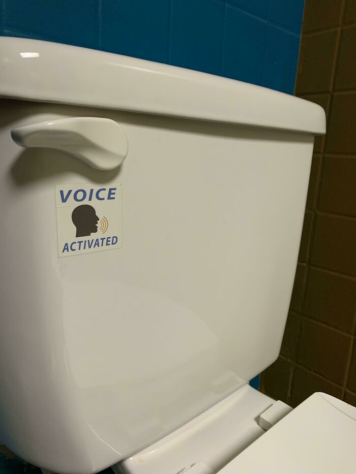 Toilet tank with a voice activated sticker on the handle as a mild vandalism prank in a restroom setting