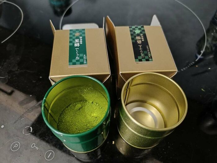 Two opened tea containers showing a disappointing shopping fail with one missing the expected green tea powder inside.