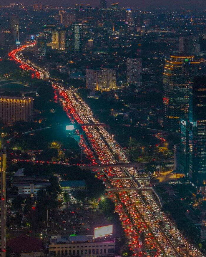 Nighttime city traffic jam with skyline in urban hell scene