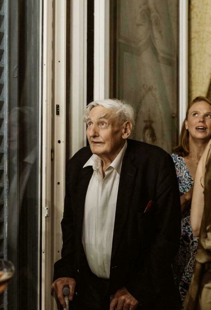 An elderly man in a suit looking up with a surprised expression in an Accidental Renaissance style portrait