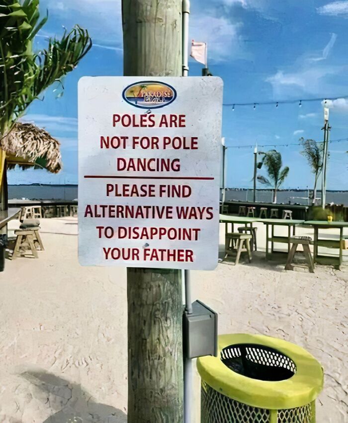 Humorous sign at beach stating poles are not for pole dancing, making people laugh or do a double take.