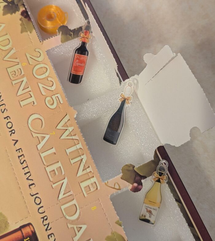 Partially opened wine advent calendar with missing and torn packaging, illustrating disappointing shopping fails.