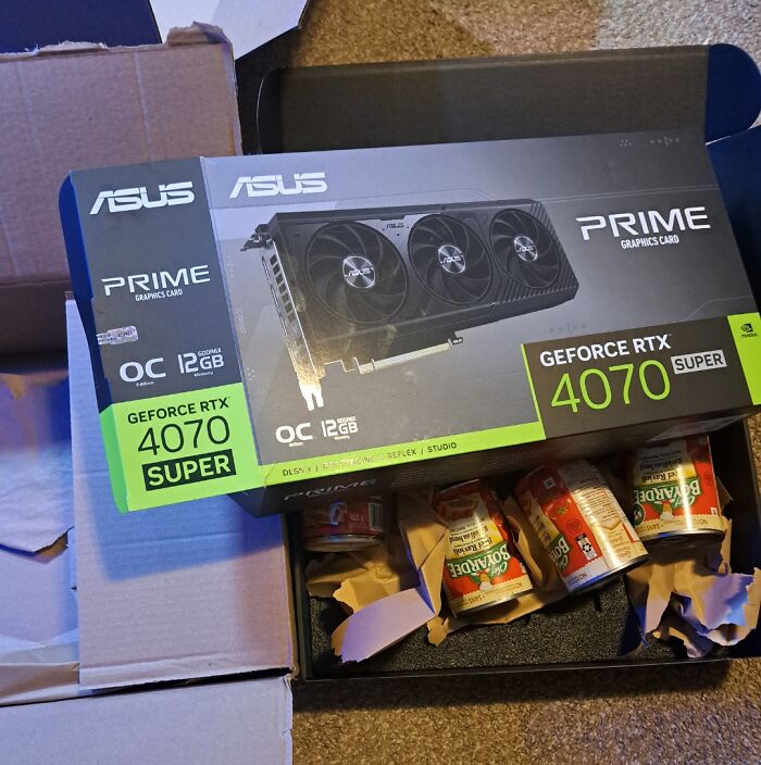 Box labeled as a graphics card reveals cans of soup inside, a disappointing shopping fail causing trust issues.