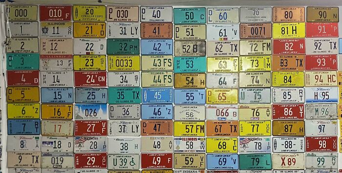 Collection of vintage license plates arranged in a grid, showcasing a unique obsession turned into a growing collection.