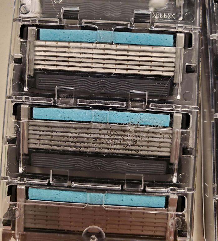 Used razor blade cartridges with dirt and debris trapped inside, illustrating disappointing shopping fails and trust issues.