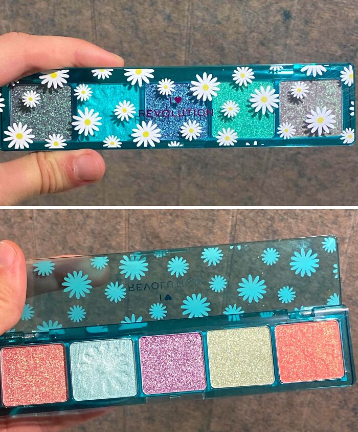 Hand holding a glitter eyeshadow palette showing a disappointing shopping fail with misleading colors and packaging design.