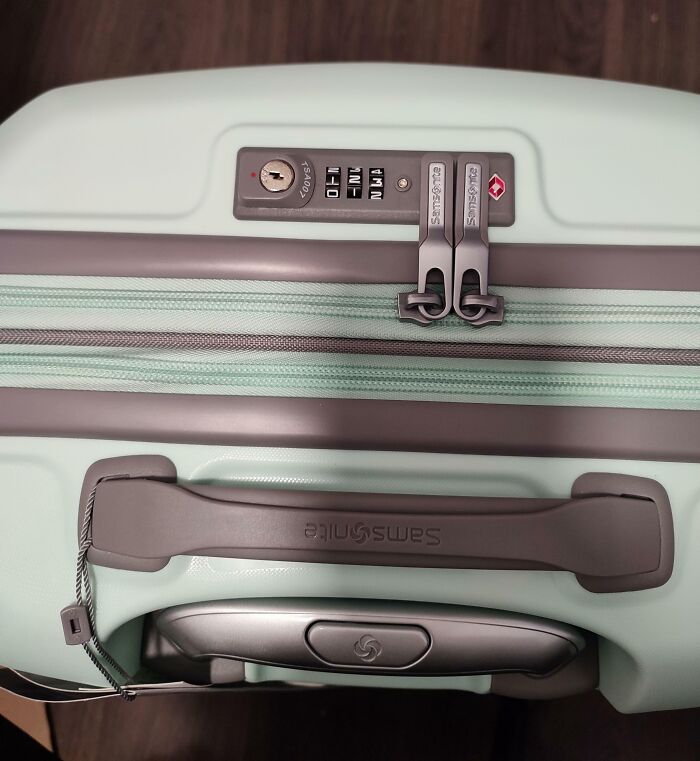 Close-up of a suitcase lock with zippers tangled, illustrating disappointing shopping fails and trust issues.