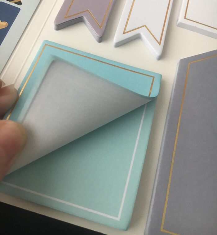 Peeling a poorly made sticky note pad with misaligned layers, illustrating disappointing shopping fails and trust issues.