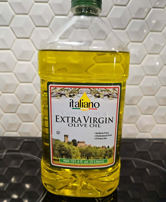 Large bottle of extra virgin olive oil with a mislabeled cap, showing a common disappointing shopping fail.