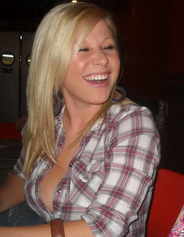 Smiling blonde woman in a plaid shirt representing the teacher who went viral after student scandal mugshot update.