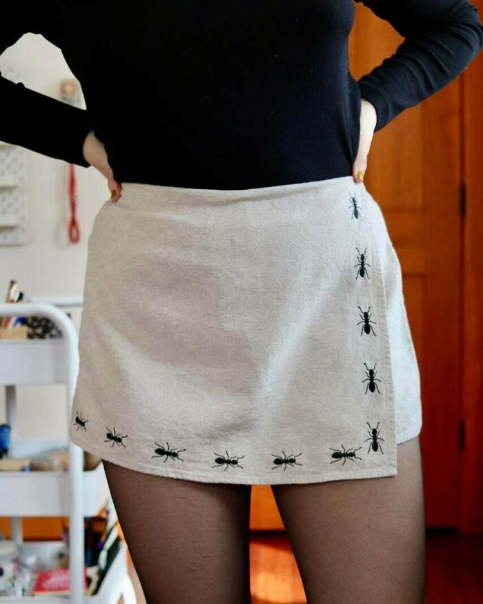 Woman wearing a skirt with unique ant embroidery creations, perfect for inspiring a new hobby.