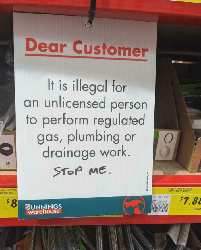 Sign in a hardware store about illegal plumbing work with mild vandalism graffiti saying Stop me, showing mild vandalism humor.