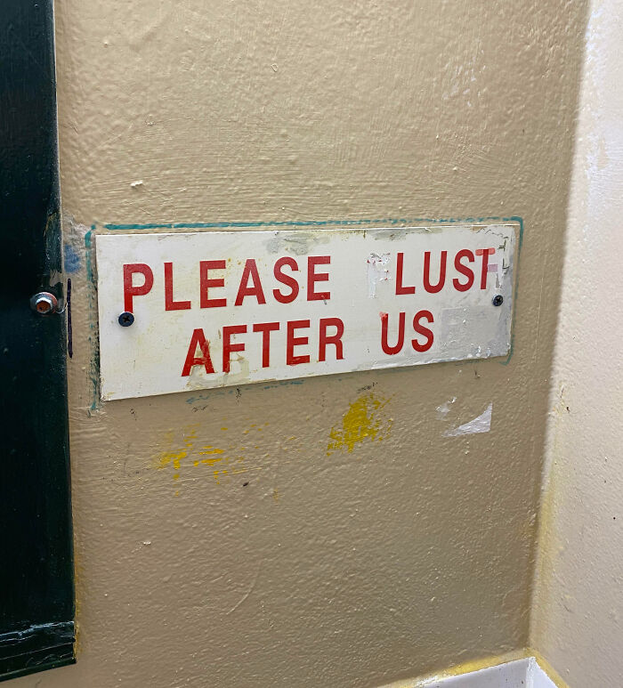 A vandalized sign with red text on a wall showing mild vandalism that alters the original message humorously.