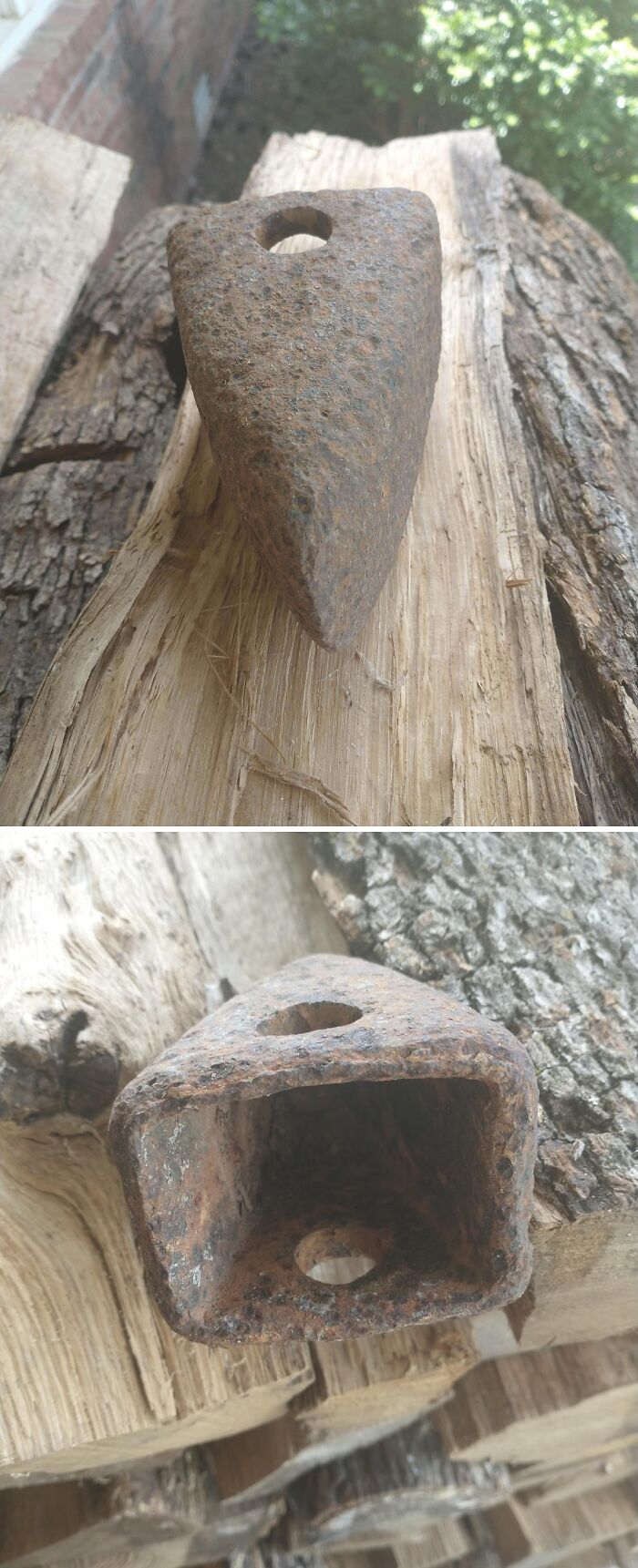 Rusty metal object with holes resting on stacked wood, captured as a strange pic causing confusion and curiosity outdoors.