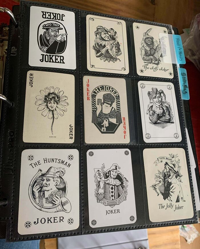 Collection of vintage joker playing cards carefully organized in a binder, showcasing an obsession turned into a unique collection.