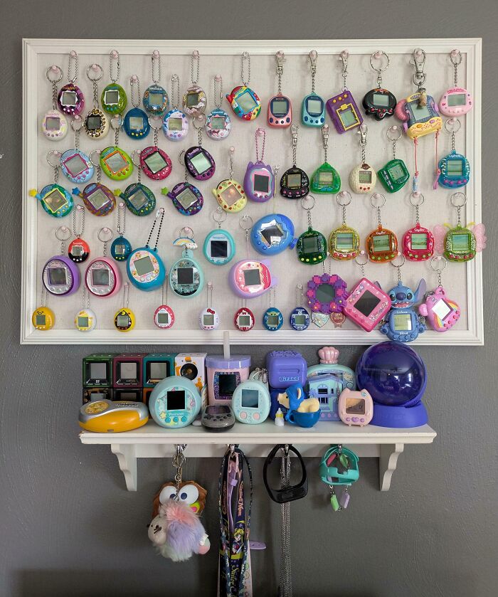 Collection of colorful virtual pets displayed on a wall, showcasing a popular obsession growing into a unique collection.