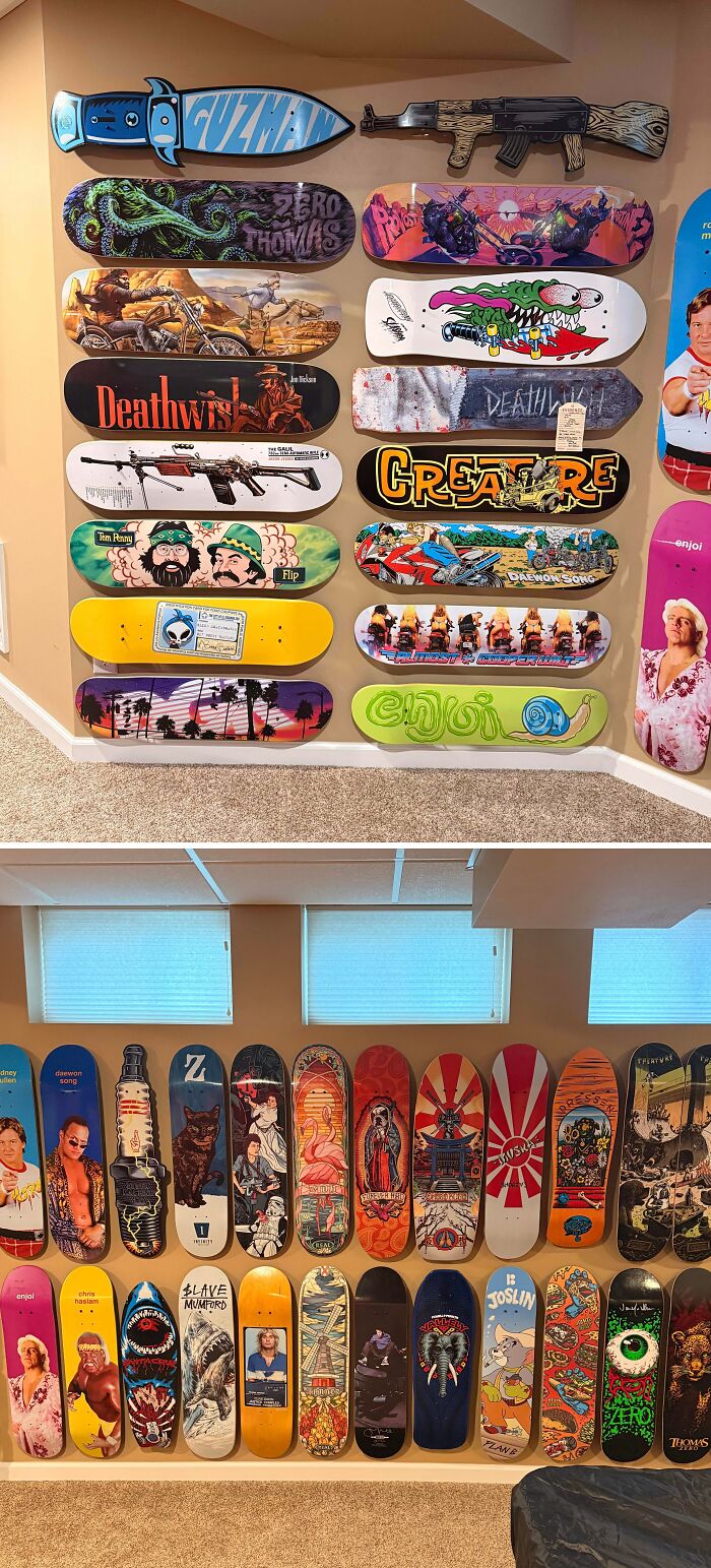 A wall display of various skateboard decks showcasing colorful and artistic designs in a collector’s room.