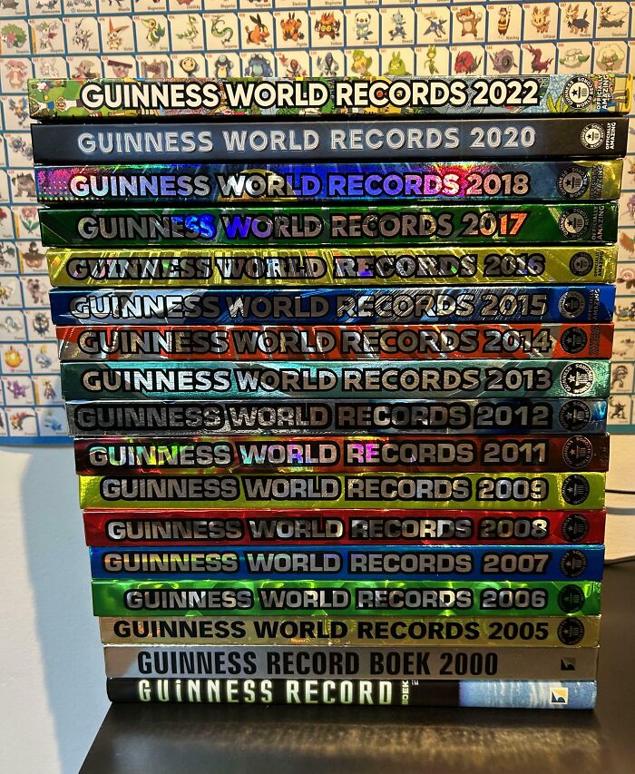 Stack of Guinness World Records books from 2000 to 2022, showcasing a unique collection from an obsessive fan.