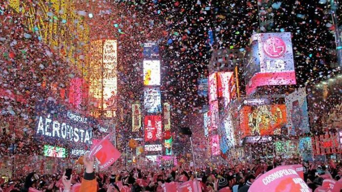 Crowd celebrating in a city square with colorful confetti falling, capturing the nostalgia of better moments in the 2010s.