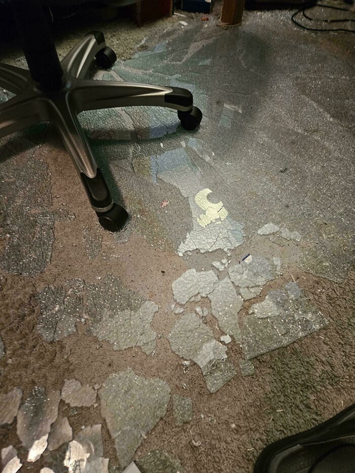 Office chair on carpet with severe damage and cracked flooring underneath, a disaster from forgetting what could go wrong.